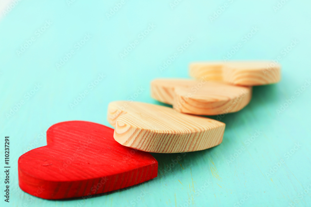 Wooden hearts on color wooden background