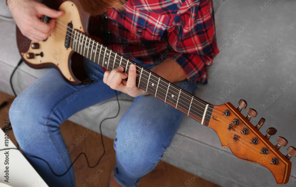 Man with guitar indoors