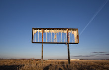 An Old Rusted Steel Billboard Frame In A Countryside Sunset
