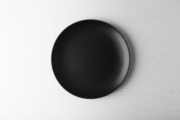 Canvas Print - Empty plate on white wooden background