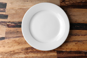 Canvas Print - Empty plate on wooden background