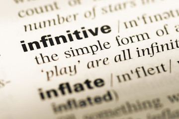 Wall Mural - close up of old english dictionary page with word infinitive