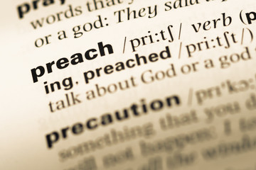 Wall Mural - close up of old english dictionary page with word preach