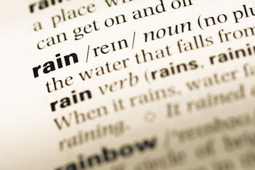 Wall Mural - Close up of old English dictionary page with word rain