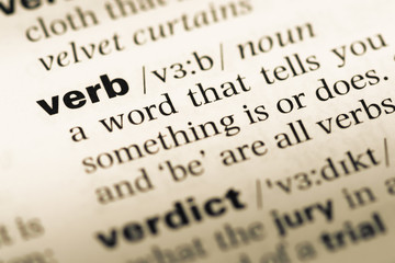 Wall Mural - close up of old english dictionary page with word verb
