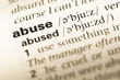 © TungCheung - Close up of old English dictionary page with word abuse