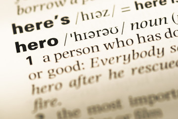 Close up of old English dictionary page with word hero