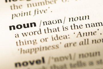 Wall Mural - close up of old english dictionary page with word noun