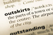 Close up of old English dictionary page with word outskirts