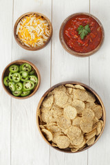 Canvas Print - bowl of nachos and condiments