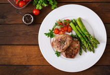 Barbecue Grilled Beef Steak Meat With Asparagus And Tomatoes. Top View