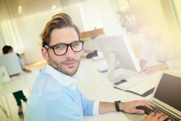 Wall Mural - Businessman with eyeglasses working in office