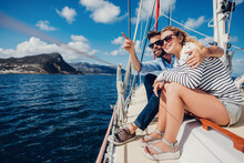 Young Couple Enjoying In Summer Day On Yacht