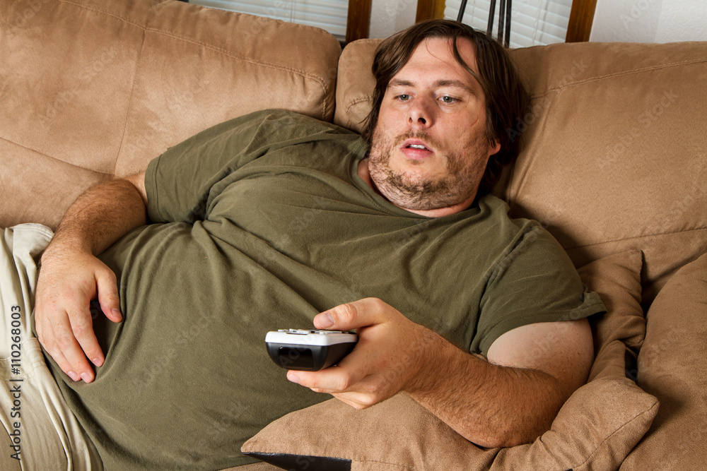 Fat lazy guy on the couch - obrazy, fototapety, plakaty 