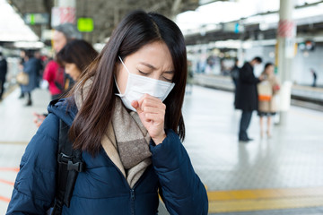 Canvas Print - Woman wearing face mask at train station