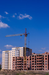 Construction of a brick high-rise building with a crane