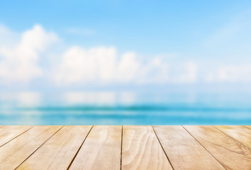 Wall Mural - Wooden table top on blue sea and white sand beach