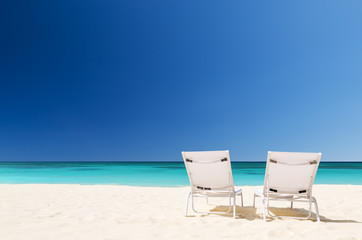 Beach chairs with umbrella and beautiful sand beach