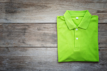 Wall Mural - Top view of color T-Shirt on grey wood plank