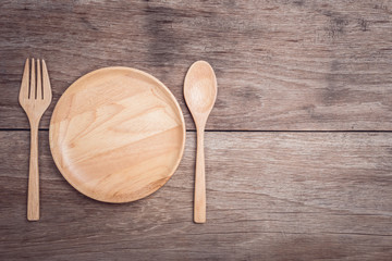 Wall Mural - Wooden dish and spoon on wooden table top view