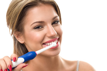 Wall Mural - Young beautiful woman brushing her healthy teeth