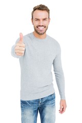 Wall Mural - Young man smiling and giving a thumbs up