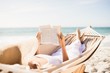 © WavebreakmediaMicro - Woman reading book in hammock