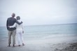 © WavebreakmediaMicro - Rear view of senior couple embracing on beach