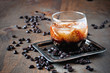 Kahlua liqueur with cream in glasses with coffee beans on a wooden background, selective focus