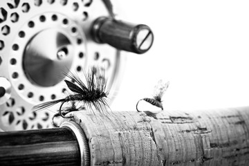 Black and White Close up of fly fishing rod and reel on white ba