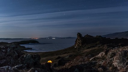 Wall Mural - Moving stars above tent at night time lapse