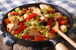 Chicken saute with mushrooms, peppers and zucchini closeup on a pan. horizontal
