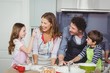 © WavebreakmediaMicro - Family enjoying while cooking food in kitchen