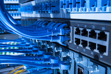 Network Cables And Hub Closeup With Fiber Optical Background