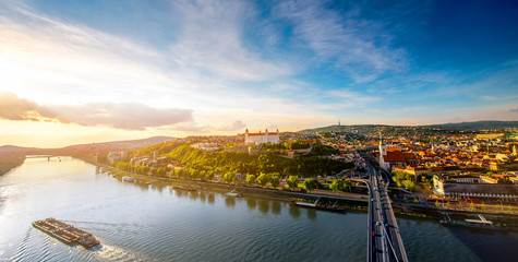 Canvas Print - Bratislava aerial cityscape view on the old town with Saint Martin's cathedral, castle hill and Danube river on the sunset in Slovakia