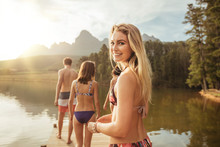 Beautiful Young Girl With Friends At A Lake