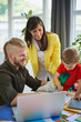 © chika_milan - Family business start up concept, man working in home office, mother with son helping him.