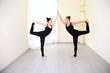 © Peakstock - Two positive women, dressed in sportswear practicing yoga