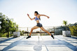 © Peathegee Inc/Blend Images - Chinese athlete running on balcony