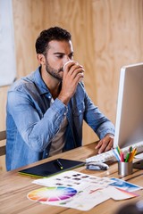 Wall Mural - An attractive man working at computer desk