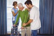 © WavebreakMediaMicro - Nurse helping seniors walking with a walker