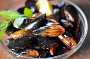 Photo of fresh mussels, lemon and fresh herbs