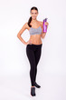 Water - an important part of my workout. An isolated portrait of a sporty young woman holding a bottle of water