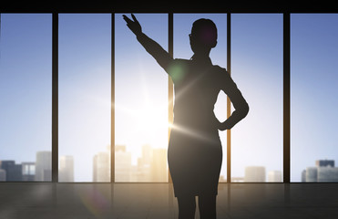 Wall Mural - silhouette of business woman pointing hand