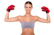 I am a winner! Happy young sporty woman in boxing gloves keeping arms raised while standing against white background