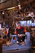 © FreeProd - Woodturners using a rotating clamp to turn the wood.