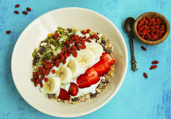 Wall Mural - Yogurt with muesli, goji berries, banana and strawberries