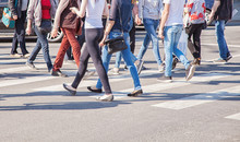 Pedestrians Walking On A Crosswalk