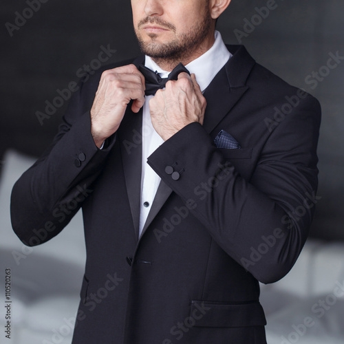 Fotografie, Tablou Sexy man dressing tuxedo and suit closeup