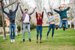 © javiindy - Group of young people jumping together outdoors